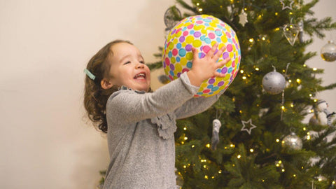 Child playing with a balloon covered in the bright ballon cover.