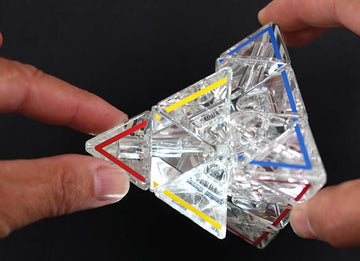 Hands moving the parts of the Megaminx puzzle.