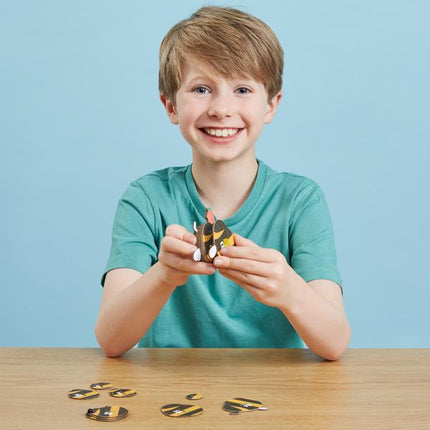 Boy putting together the pieces for the model bumblebee.