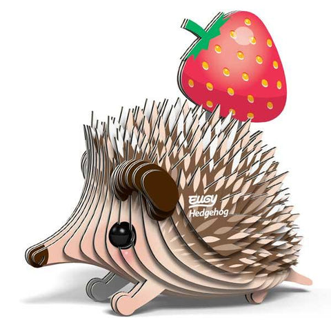 Cardboard model of a hedgehog with a red strawberry on its back.