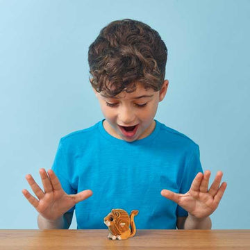 Boy holding a small model lion.