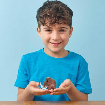 Boy holding a small Eugy model mammoth.