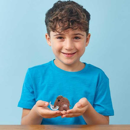 Boy holding a small Eugy model mammoth.