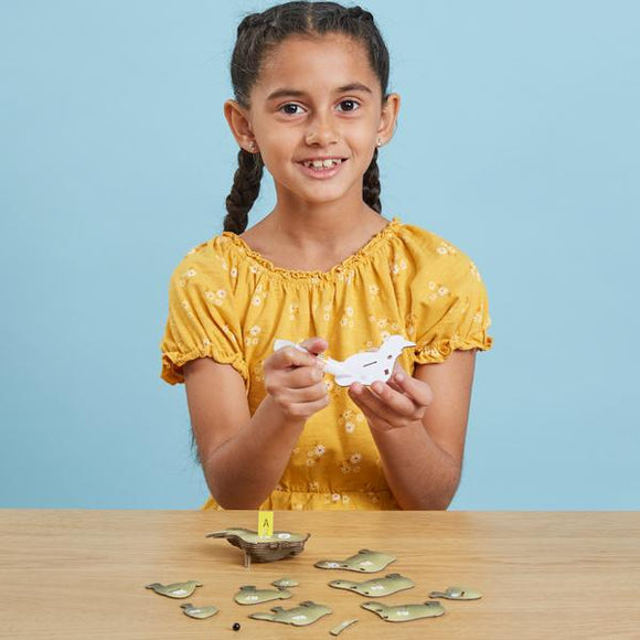 Girl with long dark hair putting the Eugy Rhino pieces together.