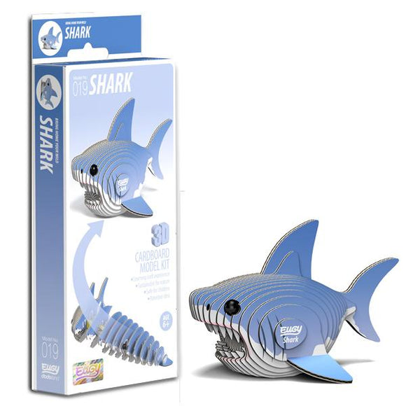 Eugy shark figure beside box.