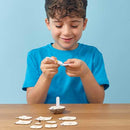 Boy with blue tshirt glueing parts of the cardboard sheep model together.
