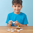 Boy with blue tshirt sticking together to make the Eugy snowman model.