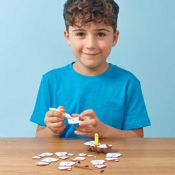 Boy with blue tshirt sticking together to make the Eugy snowman model.