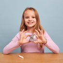 Blonde girl in long sleeved pink top holing completed wolf model in both hands.