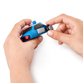 Child's hands holding wheel on the clay police car.
