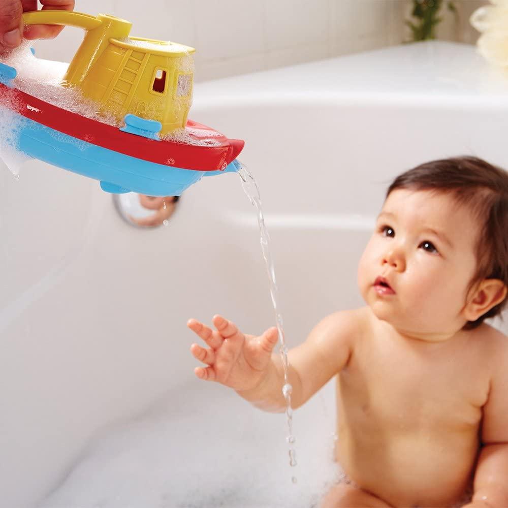 Child playing with Green Toys tug boat in the bath.