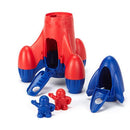 Red recycled plastic rocket taken apart with 2 spacemen standing in front.