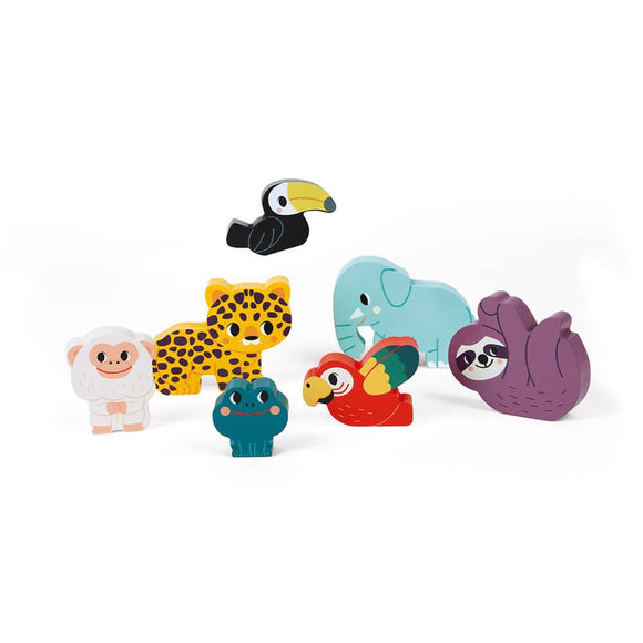 The Chunky Jungle Wooden Puzzle by JANOD features a delightful array of colorful, cartoon-like wooden animal figures crafted from FSC-certified wood. The set includes a gorilla, leopard, toucan, elephant, sloth, frog, and parrot. The pieces are arranged against a white background with the toucan appearing to be suspended in mid-air above the other animals.