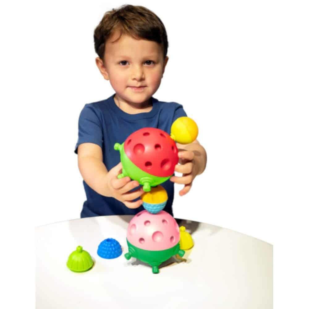 Young boy putting colourful sensory balls together.