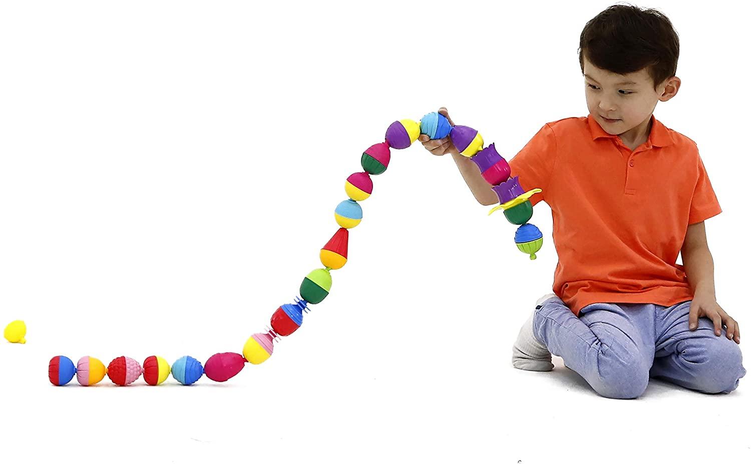 Boy playing with long string of Lalaboom brightly-coloured beads.