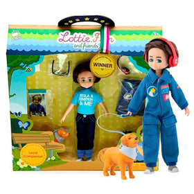 Hayden Lottie Doll standing with toy dog beside manufacturer's packaging.