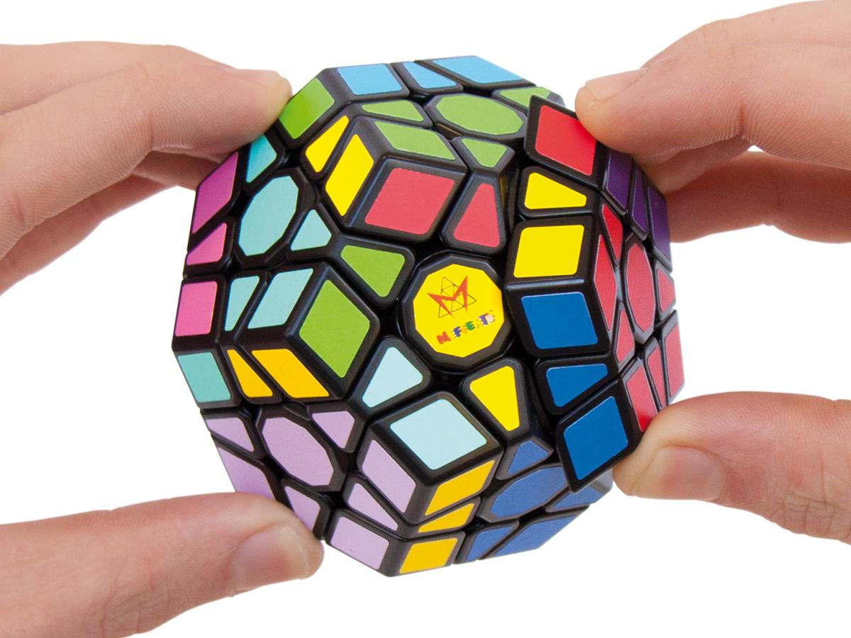 Hands moving the Molecube puzzle.