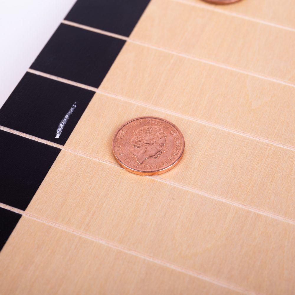 Close up view of the wooden Penny Push game.