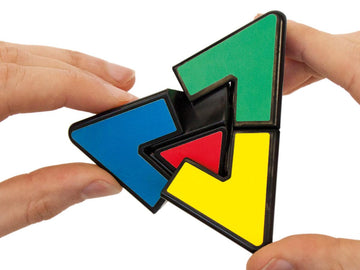 Hands moving the parts of the clear Pyraminx Crystal puzzle.