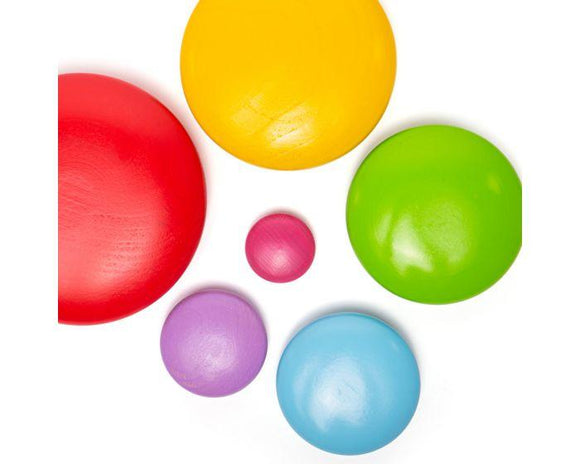 Smooth, colourful, wooden pebbles placed flat on a white surface.