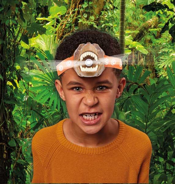 Boy wearing the T-rex-shaped head torch.