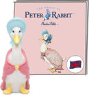 White Jemima Puddleduck figure wearing a pink cape and blue bonnet. Standing in front of the Tonie booklet for the Jemima Puddleduck story.