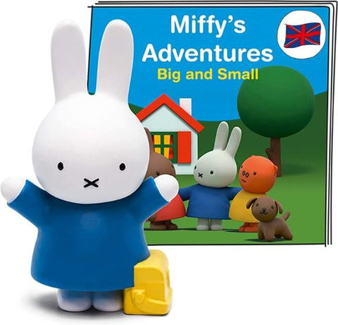 White rabbit Miffy figure with her hands held up. Wearing a blue dress and standing in fron of the booklet for the Miffy Tonie.
