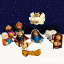 Nativity figures including characters and animals with dark blue back drop and pale foreground.