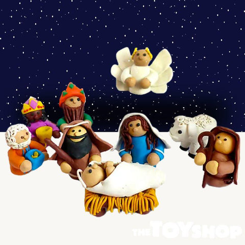Nativity figures including characters and animals with dark blue back drop and pale foreground.