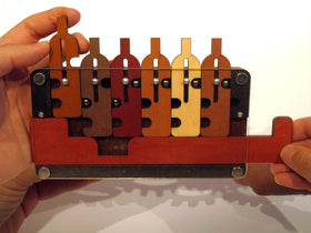 Hands sliding the wooden bottles in The Waiter's Tray games.