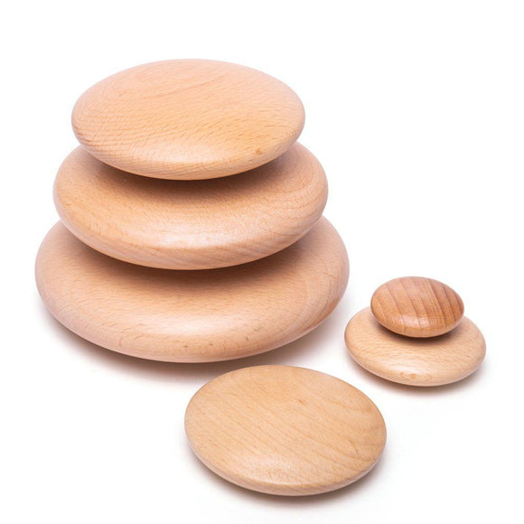3 wooden pebbles stacked with another 3 around.