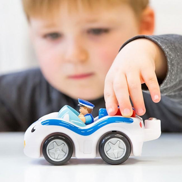 Child playing with cop car.