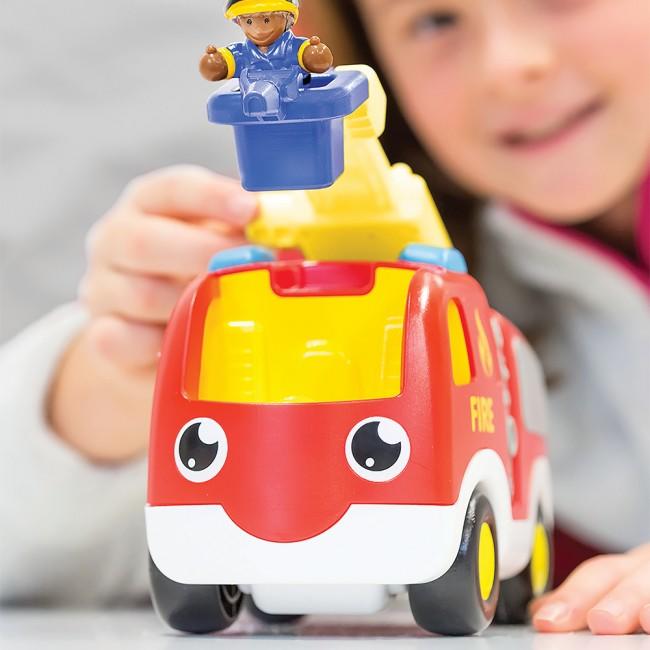 Close up of young child playing with fire truck set.