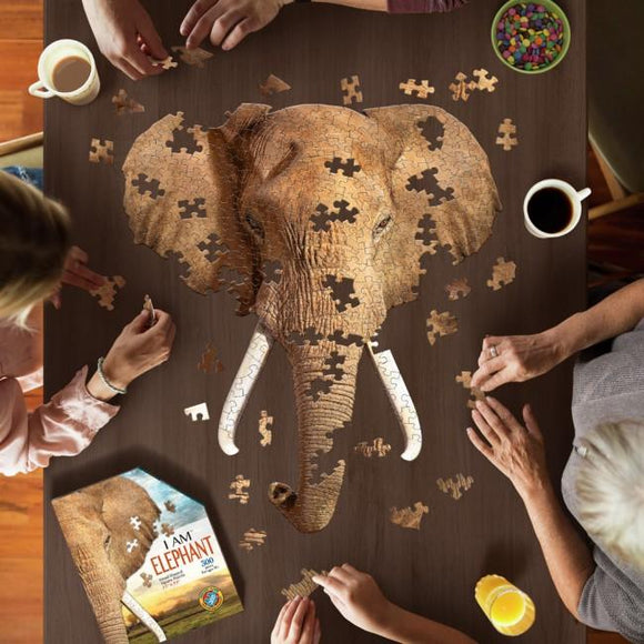 Image shot from above of people putting together the large elephant head jigsaw.