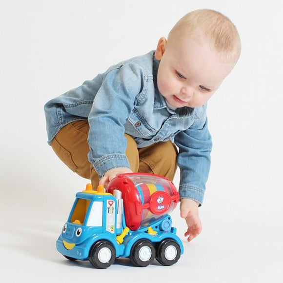 Child playing with cement mixer play set.